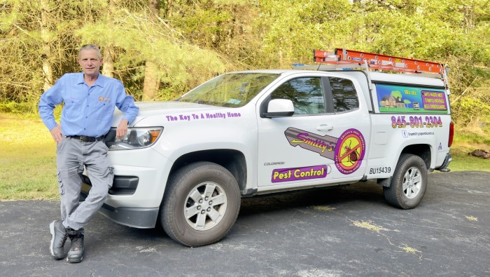 Smitty standing in front of his truck for pest control services.