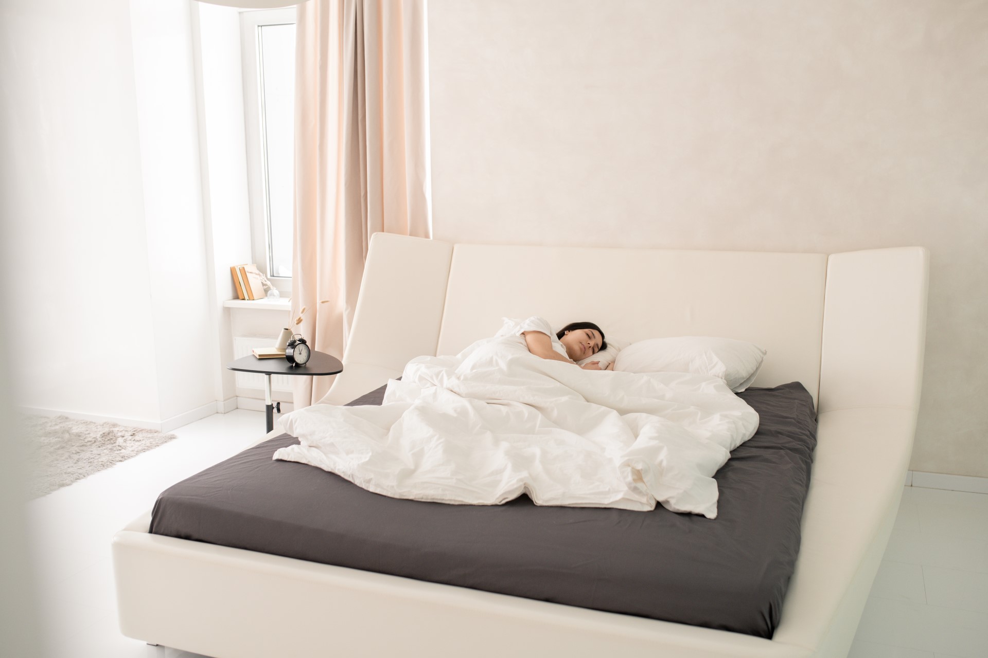 A relaxed young woman sleeping in her bed.